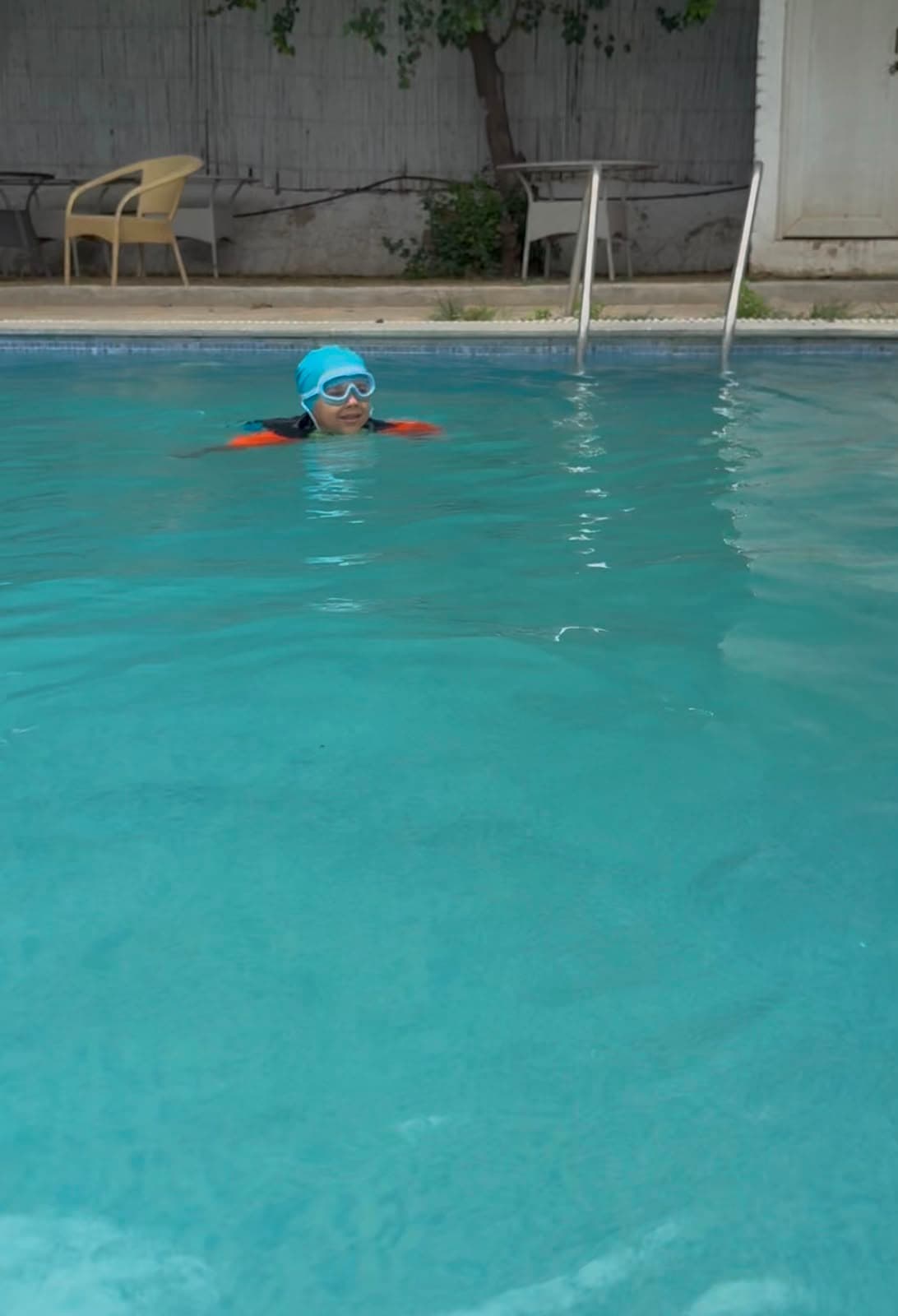 Child swimming in a pool during hydrotherapy